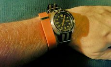 Orange FitBit Flex on arm with Seiko Automatic Diver