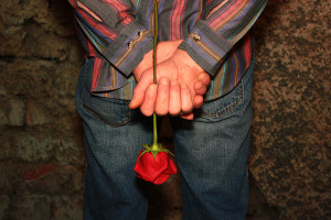 Man Holding A Red Rose