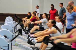 U.S. Air Force Master Sgt. Bradford Godwin, Air Force Weather Agency, uses the concepts two rower with other Team Offutt members during the tactical fitness class in the field house on Offutt Air Force Base, Neb., April 2. (U.S. Air Force photo by Charles Haymond/Released)