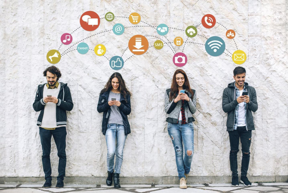 4 people lined up using their phones